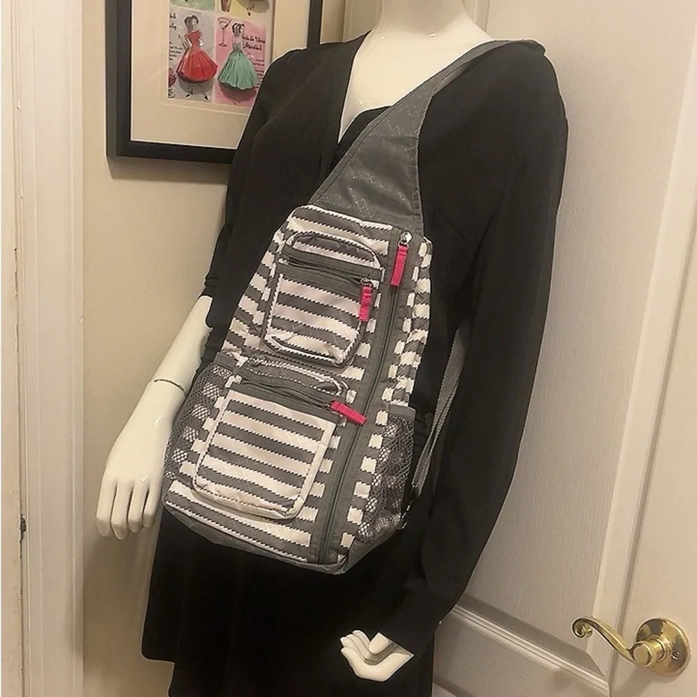 Thirty one grey and white stripes with
pink accents crossbody bag.